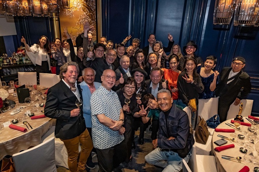 HONG KONG, CHINA - APRIL 14: Chow Yun Fat, Michelle Yeoh and all guests take a selfie during an Oscar celebration dinner at Man Wah at Mandarin Oriental, Hong Kong on 14 April in Hong Kong, China. (Getty Images for Mandarin Oriental, Hong Kong)